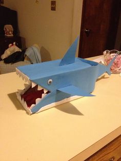 a shark made out of paper sitting on top of a counter