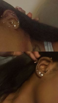 a woman getting her ear pierced by another person