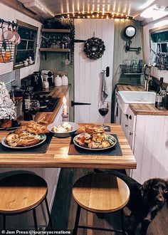 two plates of food are sitting on the counter in this small kitchen with stools