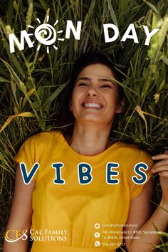 a woman laying in the grass with her eyes closed, smiling and wearing a yellow shirt that says vibes