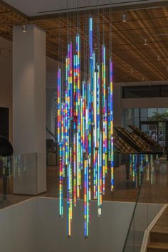 a large multicolored chandelier hanging from the ceiling in a lobby area