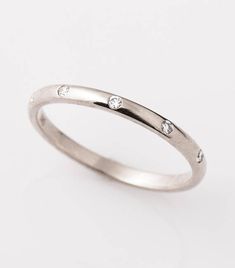 a white gold ring with three diamonds