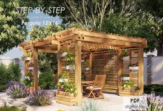 a wooden pergola sitting next to a lush green forest