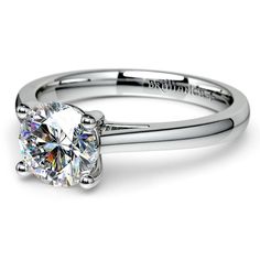 a white gold engagement ring with a round cut diamond