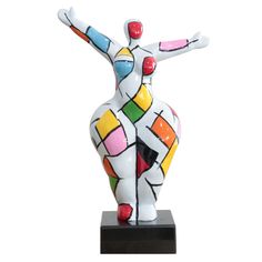 a ceramic sculpture of a woman with her arms outstretched