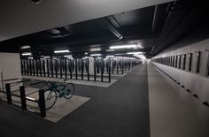 there is a bike that is parked in the parking garage with lots of racks on the wall