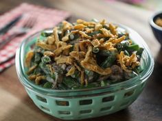 a bowl filled with food sitting on top of a wooden table