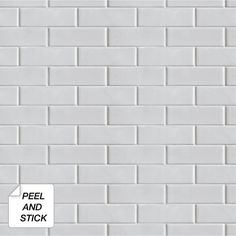 a white brick wall with peel and stick on it