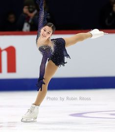 a female figure skating on an ice rink