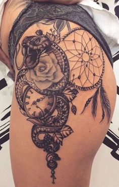 a woman's thigh with a tattoo on it and a rose in the center