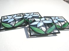 three stained glass coasters sitting on top of a table