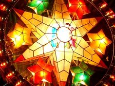 a lighted star is in the middle of a circular arrangement with many lights around it