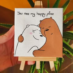 a hand holding an easel with a painting on it that says, you care my happy place