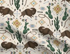 an image of bison and cactus pattern on white fabric