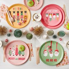 a table set for christmas with plates and napkins