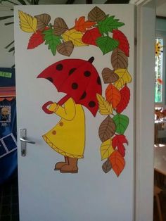 the door is decorated with an image of a ladybug holding an umbrella