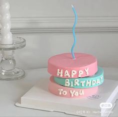 a birthday cake with the words happy birthday to you on it and a lit candle