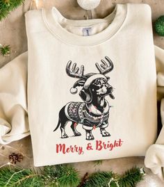 a white t - shirt with an image of a reindeer on it and merry and bright written across the chest