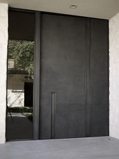 an image of a black door on the side of a building