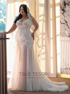 a woman in a wedding dress standing by a window with her hands on the railing