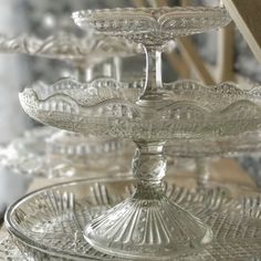 three tiered glass cake plate on top of a wooden table