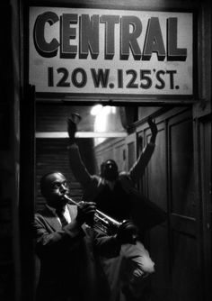 black and white photograph of two men standing in front of a sign that reads central