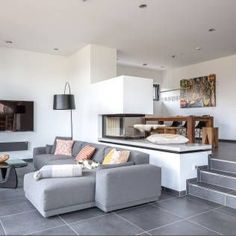 a living room filled with furniture and a flat screen tv mounted to the side of a wall