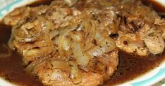 meat and onions in gravy on a blue and white plate with green stripes