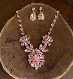 "Pink necklace set Beautiful blush pink teardrop cluster crystal rhinestone necklace and earrings set are a great statement piece! Prom, pageant, or Bridal! Or an evening out! Size of earrings: 1.5\" Long. Necklace 18.5\"long with 3\" chain extender Decor Size: 2.25\" Color: rose pink / blush Base metal color: gold More colors available upon request, just message us! Need a matching bracelet? https://www.etsy.com/listing/1196317789/pink-rose-gold-bracelet-wide-pink?click_key=faa6b911fdc3999350154ef3d4844864e7cac6b7%3A1196317789&click_sum=15c68f94&ga_search_query=pink&ref=shop_items_search_37&pro=1&frs=1&sts=1 https://www.etsy.com/listing/690752461/pink-bracelet-rose-pink-bracelet-rose?ref=shop_home_active_14 https://www.etsy.com/listing/661759254/pink-bracelet-pink-rhinestone-bracelet?ref= Rose Pink Necklace, Pink Necklace Set, Prom Necklace, Pink Statement Necklace, Prom Necklaces, Neck Pieces Jewelry, Prom Accessories, Pink Wedding Flowers, Rose Blush