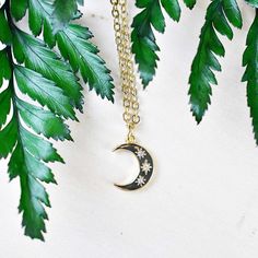 This necklace is made from a gold plated pendant. The charm is in the shape of a crescent moon. The front of the crescent moon has three stars with clear cz crystals. The necklace is finished off with a gold plated stainless steel chain. You can choose the style and length of the chain. Please choose the length you would like the necklace in. Please choose the chain style you would like your pendant on. Please note that all necklaces are handmade and may differ from the pictured. The picture sho Celestial Crescent Moon Phase Necklace, Gold Crescent Celestial Necklace, Celestial Crescent Gold Necklace, Celestial Crescent Charm Necklaces With Adjustable Chain, Celestial Crescent Necklace With Adjustable Chain, Gold Crescent Charm Necklace With Clavicle Chain, Gold Crescent Clavicle Chain Charm Necklace, Celestial Crescent Brass Necklace, Crescent Moon Charm Necklace