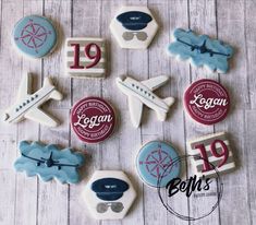 decorated cookies are arranged in the shape of airplanes and numbers on a wooden table top