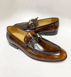 Maurice Polished Calfskin Slip-On Loafer with H Buckle Elegant Polished Leather slip-on Loafer from the Maurice collection features a clean welt, Silver H Buckle and a full Leather Sole! Leather Slip Ons, Cognac, Calf Skin, Loafers, Buckle, Slip On, Silver, Leather