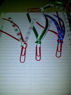 three red, white and blue paper clips on lined notebook