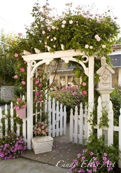 a white picket fence with pink flowers on it