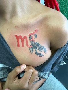 a woman with a scorpion tattoo on her chest