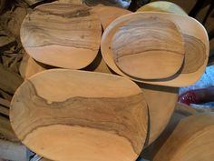 four wooden bowls sitting on top of each other