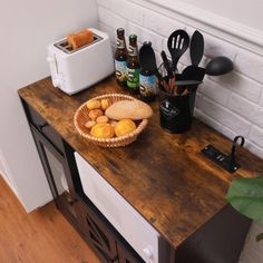 a wooden counter topped with lots of cooking utensils and food on top of it