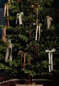 a christmas tree decorated with ribbons and bows