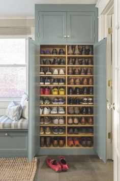 an organized closet with shoes on the floor