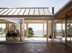 an open patio with sliding glass doors leading to the ocean