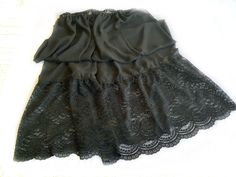 Pretty Sheer fabric Skirt or Slip with adjustable elastic waist. Extra long Skirt with Scallop edge lace ruffles.   Large size Slip measurement  30 inches wide elastic adjustable waist  41 inches long from top of of waist to bottom of ruffles.  17 inches long lace ruffles finished.  Hand spot wash only.  Hang dry. Fitted Black Long Petticoat, Black Stretch Petticoat For Spring, Black Spring Petticoat, Black Flowy Petticoat For Spring, Spring Black Flowy Petticoat, Black Skirted Summer Petticoat, Summer Black Skirted Petticoat, Spring Black Petticoat, Black Stretch Tiered Skirt