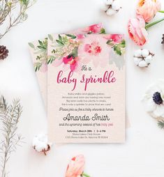 a baby sprinkle is on the table next to flowers and cotton floss