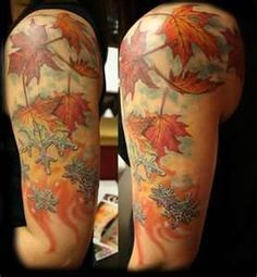 a woman's arm with leaves and snowflakes on it