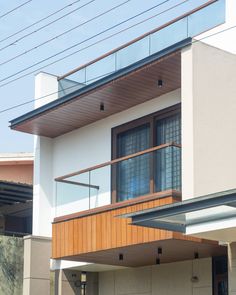 an apartment building with wooden balconies on the second floor and balcony above it