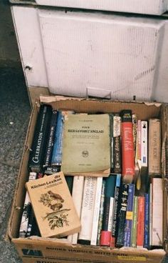 a box full of books sitting on the ground