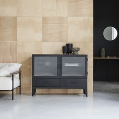 a black cabinet sitting next to a white chair