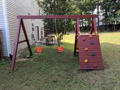 a wooden swing set with plastic cups on it