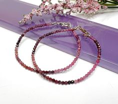 This dainty natural ruby beaded gemstone bracelet is made with small approximately 2mm to 2.5mm faceted ombre shaded Ruby gemstone beads, carefully strung on flexible aluminum wire and finished with a clasp of your choice. These gorgeous stones are not heat treated or color enhanced and show off the prettiest shades of raw ruby! 𝗢𝗣𝗧𝗜𝗢𝗡𝗦 + 𝗖𝗨𝗦𝗧𝗢𝗠𝗜𝗭𝗔𝗧𝗜𝗢𝗡 ● Different lengths are available for most pieces, allowing you to wear them as a bracelet, wrap bracelet, anklet, choker, or Customised Bracelets, Raw Ruby, Bead Choker, Ruby Beads, Ruby Necklace, Handmade Jewelry Gift, July Birthstone, Bracelet Clasps, Pink Ombre