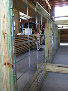 the inside of a building with wooden slats and metal bars on it's sides