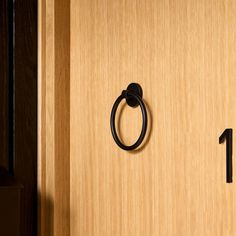 a door handle on a wooden door with the number one